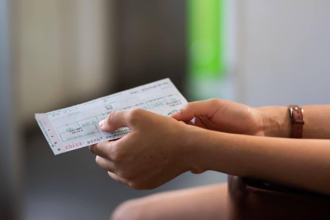 A traveller holding a flight ticket